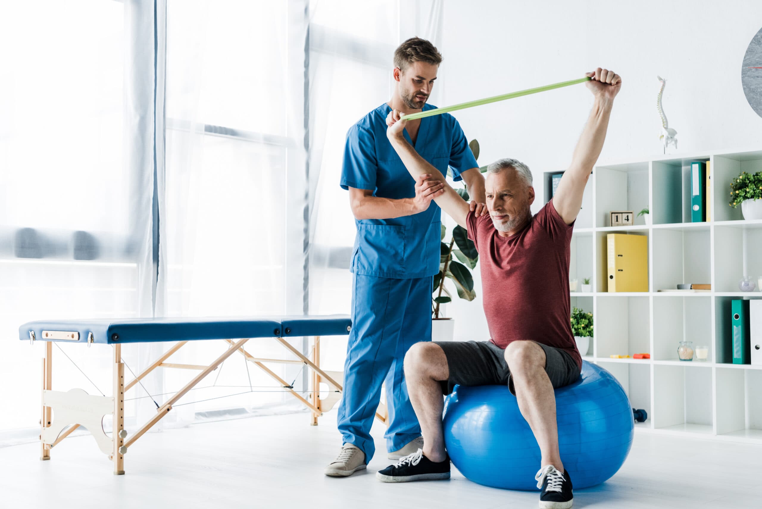 Caregiver assisting a resident with a physical therapy exercise